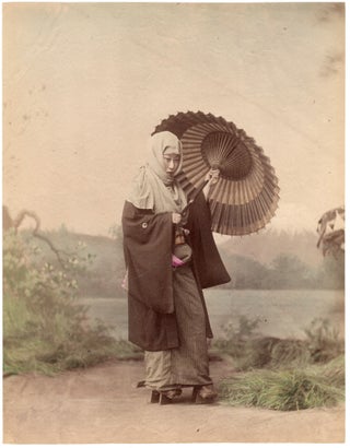 1847 Japan – Woman in winter outfit with umbrella (studio photo, with painted background of Mt....